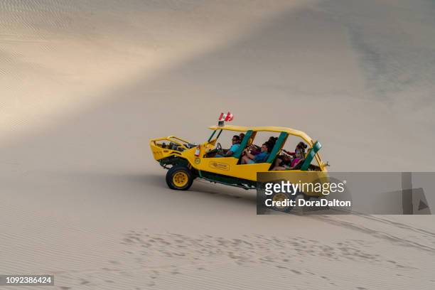 beach buggy on beside oasis in huacachina, peru - huacachina stock pictures, royalty-free photos & images