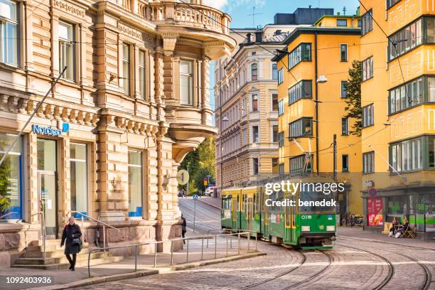 typical green-yellow tram in downtown helsinki finland - helsinki imagens e fotografias de stock