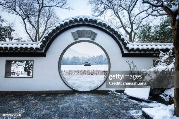 the classcial chinese garden and bungalow in hangzhou after snow - garden bridge stock pictures, royalty-free photos & images