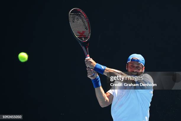 Paolo Lorenzi of Italy plays a backhand in his match against Daniel Evans of Great Britain during Qualifying ahead of the 2019 Australian Open at...