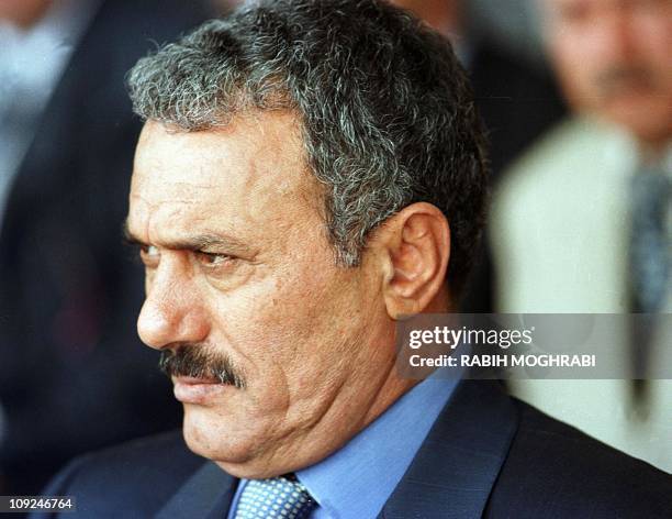 Yemeni President Ali Abdullah Saleh stands outside a polling station in Sanaa, 23 September 1999, after casting his vote in the Arabian peninsula's...