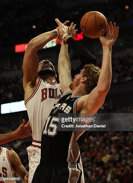Carlos Boozer of the Chicago Bulls is fouled while shooting by Matt Bonner of the San Antonio Spurs at the United Center on February 17, 2011 in...