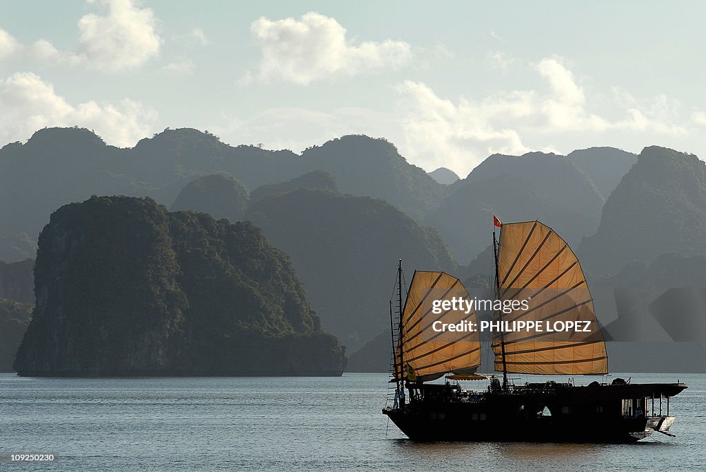 A tourist boat sails past the stone isla