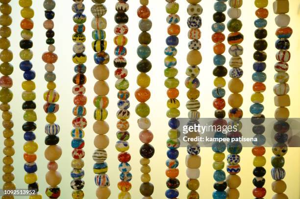 colorful ceramic bead curtain close up - bead string stock pictures, royalty-free photos & images