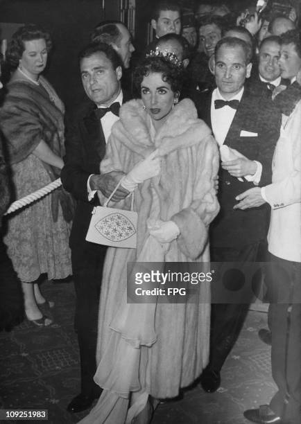 British-born actress Elizabeth Taylor and her husband, producer Mike Todd after an inaugural screening of his film 'Around the World in Eighty Days'...