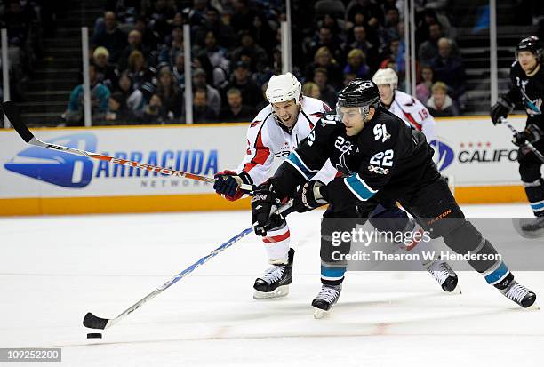 Dan Boyle of the San Jose Sharks fights for the puck with Mike Knuble of the Washington Capitals in the third period during an NHL hockey game at the...