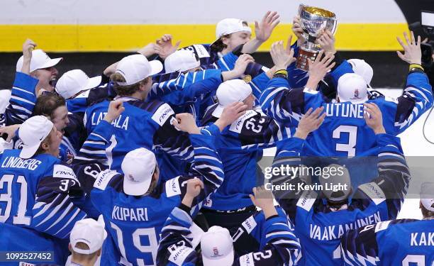 Finland celebrates with the trophy after a victory against the United States following the gold medal game at the IIHF World Junior Championships at...