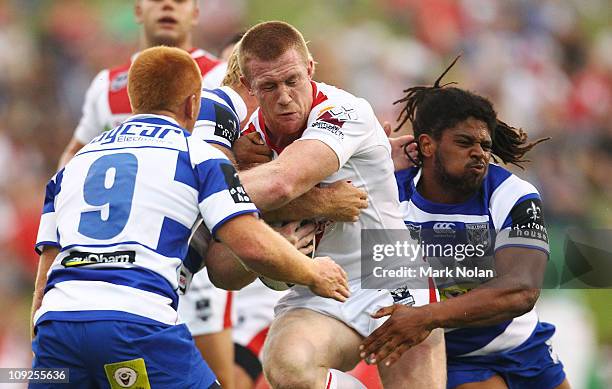 Ben Creagh of the Dragons is tackled during the NRL trial match between the St George Illawarra Dragons and the Canterbury Bulldogs at WIN Stadium on...