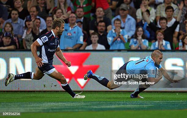 Drew Mitchell of the Waratahs scores a try during the round one Super Rugby match between the Melbourne Rebels and the Waratahs at AAMI Park on...