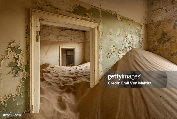 sand filled corner in an abandoned house in kolmanskop, namibia. full colour horizontal image - kolmanskop namibia stock pictures, royalty-free photos & images