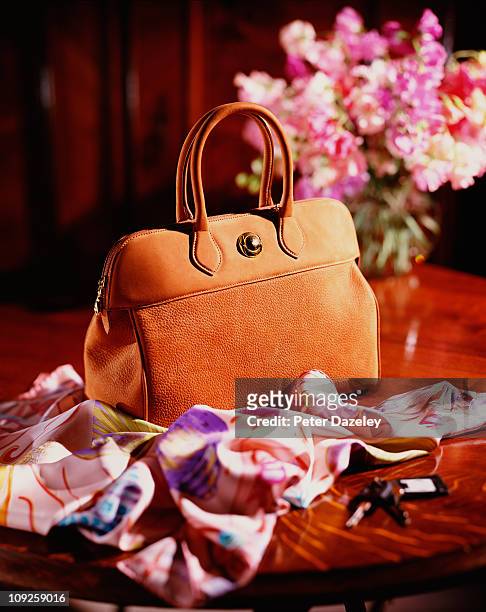 luxury hand bag on table - handtasche stock-fotos und bilder