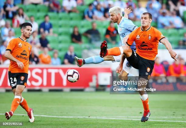 Luke Brattan of the City competes for the ball against against Luke DEVERE of Brisbane Roar during the round 13 A-League match between Melbourne City...
