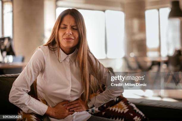 woman with a stomach ache - indigestion stock pictures, royalty-free photos & images
