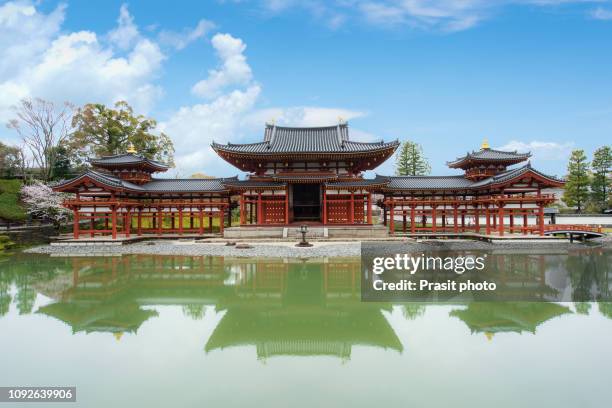 kyoto, japan - april 7,2017 : byodo-in temple during cherry blossom season in uji, kyoto, japan. - byodo in temple kyoto stock pictures, royalty-free photos & images