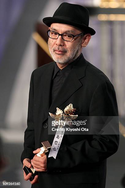 Director Tetsuya Nakashima accepts the award for Best Director for 'Kokuhaku ' during the 34th Japan Academy Awards at Grand Prince Hotel New...