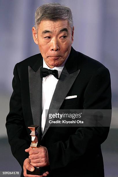 Actor Akira Emoto accepts the award for Best Actor in a Supporting Role for 'Akunin ' during the 34th Japan Academy Awards at Grand Prince Hotel New...