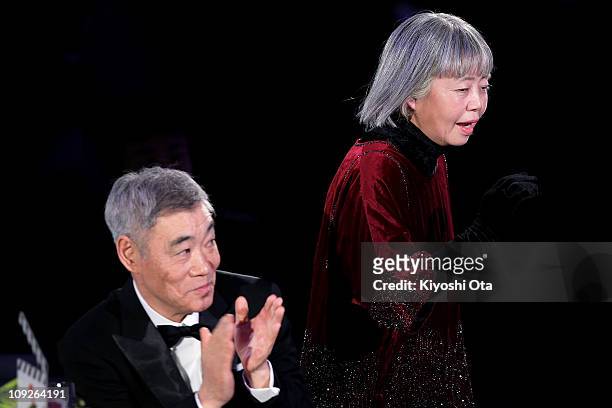 Actress Kirin Kiki accepts the award for Best Actress in a Supporting Role for 'Akunin ' while actor Akira Emoto looks on during the 34th Japan...