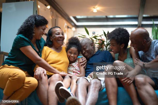 multi-generation african hispanic family at home - multi generation family black stock pictures, royalty-free photos & images