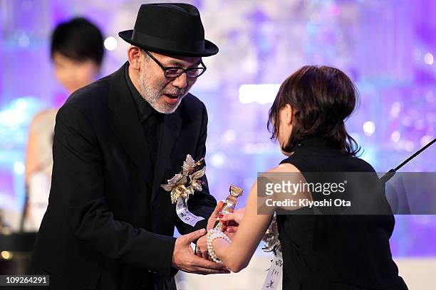 Director Tetsuya Nakashima accepts the Best Screenplay award for 'Kokuhaku' on stage during the 34th Japan Academy Awards at Grand Prince Hotel New...