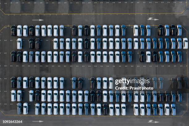 aerial view new cars lined up in the port for import and export. - car exports stock-fotos und bilder