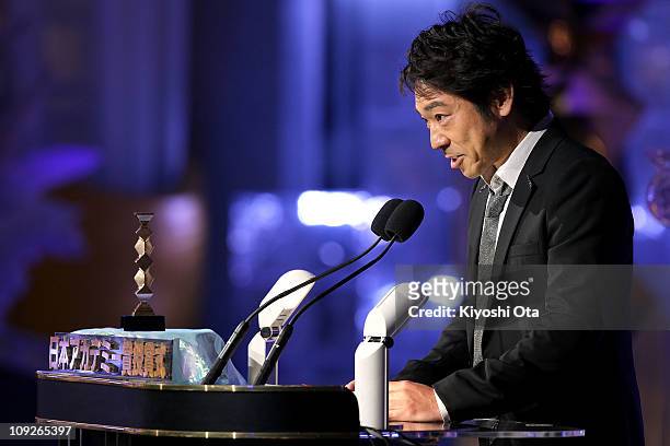 Actor Teruyuki Kagawa presents the award for Best Actress in a Supporting Role onstage during the 34th Japan Academy Awards at Grand Prince Hotel New...