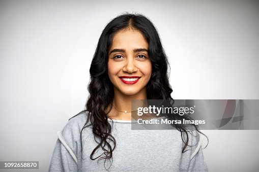 Young woman smiling against white background Young woman smiling against white background