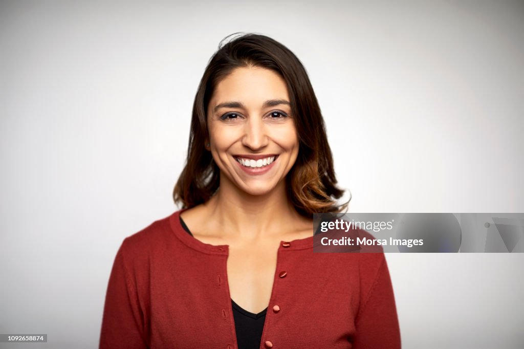 Portrait of woman smiling on white background