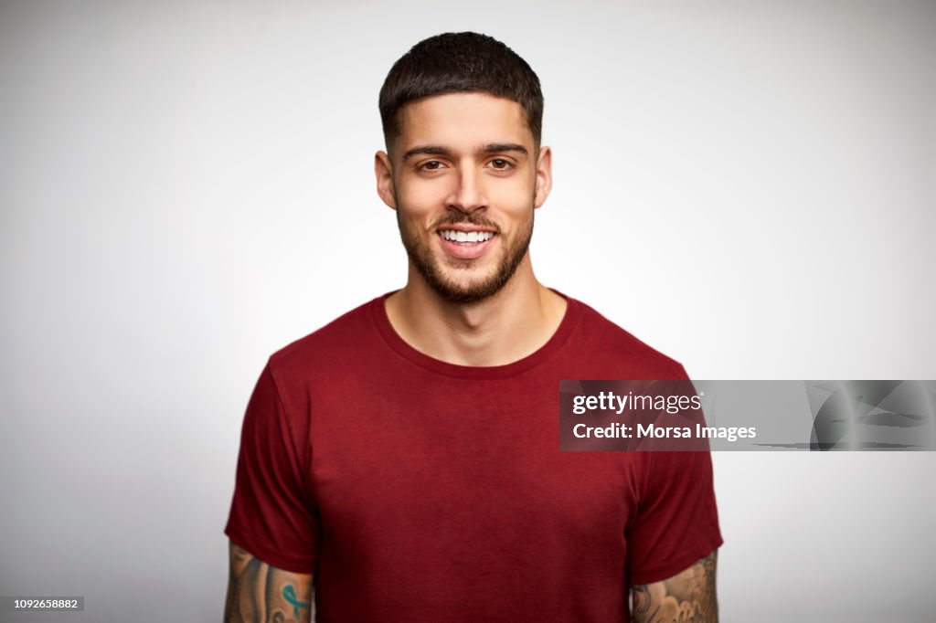 Portrait of smiling young man wearing t-shirt