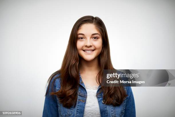 portrait of smiling teenage girl on white - girl long hair stock pictures, royalty-free photos & images