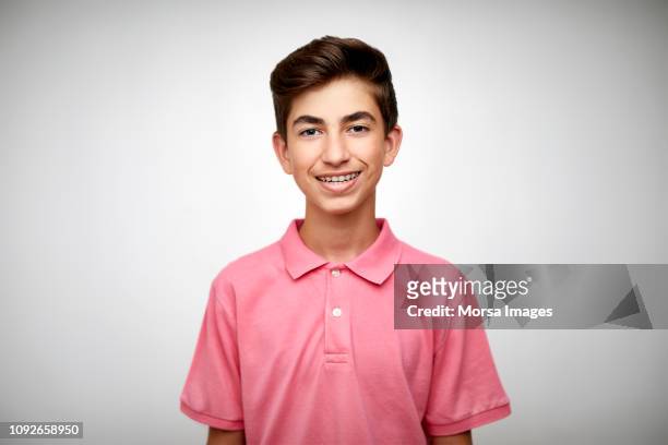 smiling teenage boy on white background - boys foto e immagini stock
