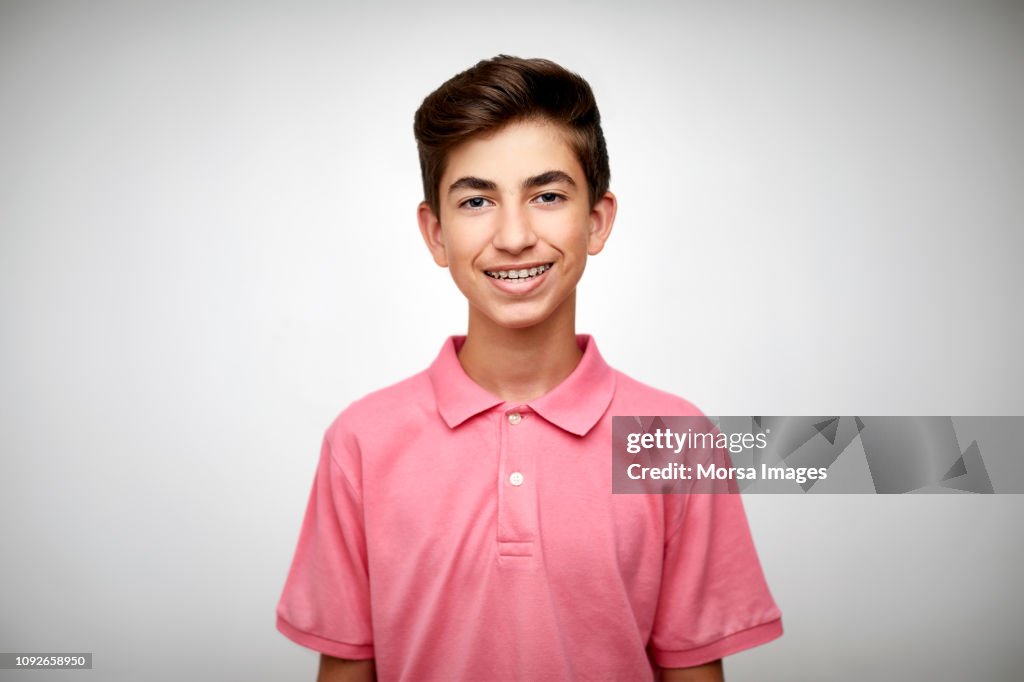 Smiling teenage boy on white background