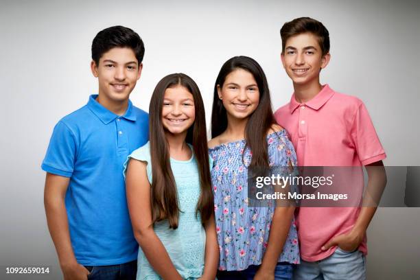 smiling teenage friends on white background - family formal portrait stock pictures, royalty-free photos & images