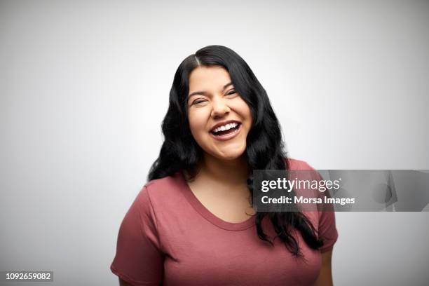 portrait of cheerful woman on white background - indian faces stock-fotos und bilder