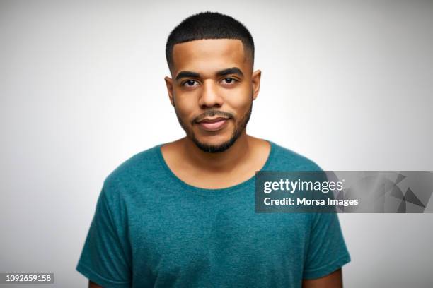 portrait of confident young man wearing t-shirt - close up faces white background stock pictures, royalty-free photos & images