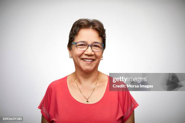 portrait of happy senior woman wearing eyeglasses - colombiaanse etniciteit stockfoto's en -beelden