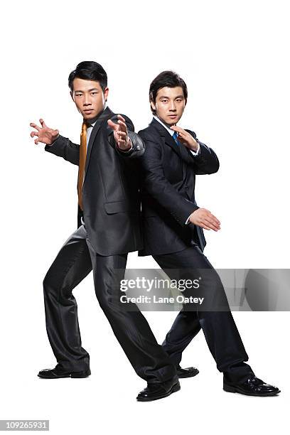 two businessmen in fighting stance - カンフー ストックフォトと画像