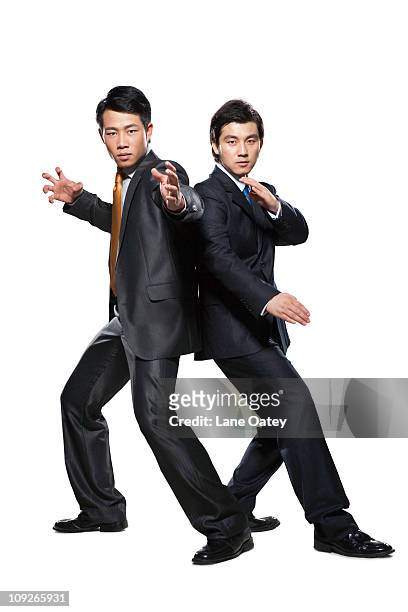 two businessmen in fighting stance - kung fu pose stock pictures, royalty-free photos & images