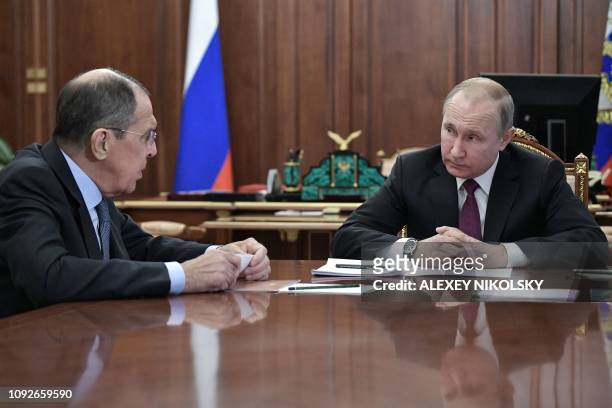 Russia's President Vladimir Putin attends a meeting with Russia's Foreign Minister Sergei Lavrov and Russia's Defence Minister in Moscow on February...