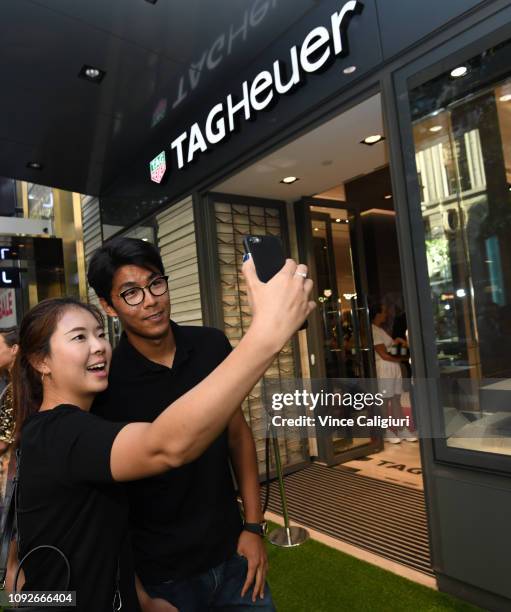 Chung Hyeon of South Korea poses with a fan at the Unveiling of Tag Heuer’s Global Tennis Ambassadors at the Tag Heuer Boutique on January 11, 2019...