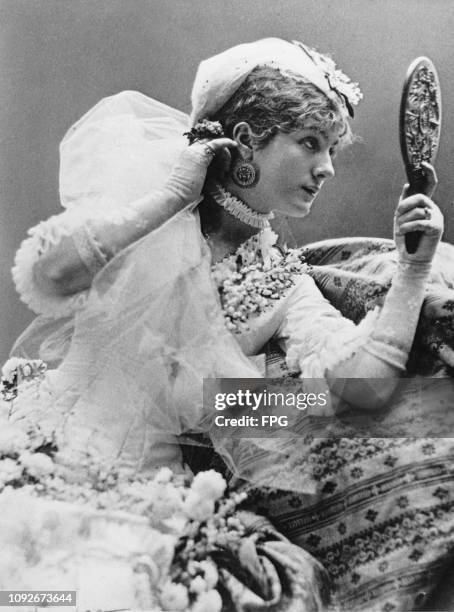 Victorian stage actress Venie Clancey admires herself in a hand mirror, circa 1880. Born Lavinia Gardiner in Cincinnati, she died of tuberculosis in...