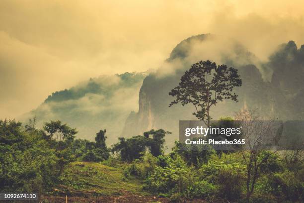 extreme terrain landscape misty phangern mountain range, vang vieng, laos - laos stock pictures, royalty-free photos & images