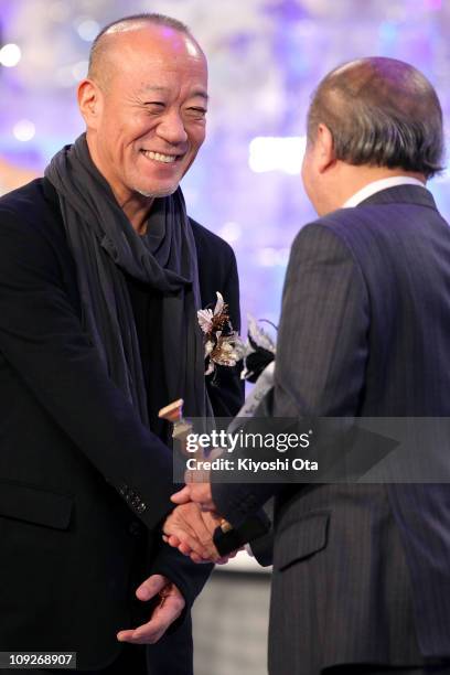 Composer Joe Hisaishi accepts the award for Best Music for 'Akunin' on stage during the 34th Japan Academy Awards at Grand Prince Hotel New Takanawa...