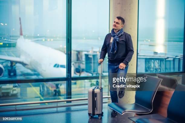 passenger waiting for his flight at the airport - airport zurich imagens e fotografias de stock