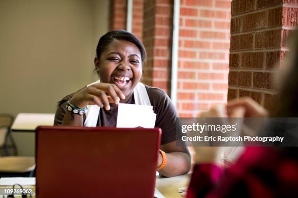 laughing african american woman sitting in cafe - tarjeta de ilustración fotografías e imágenes de stock
