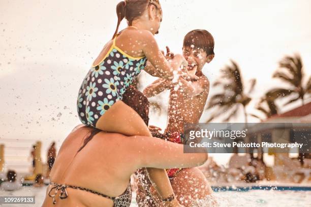 happy family playing together in swimming pool - hot mexican girls stock pictures, royalty-free photos & images