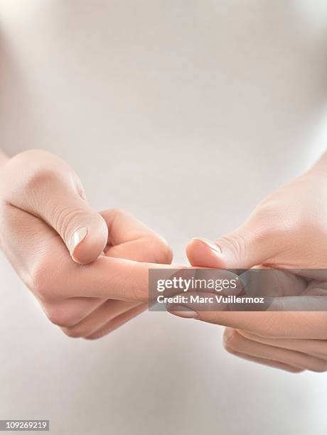 woman pinching finger, close-up - pressure point stock pictures, royalty-free photos & images