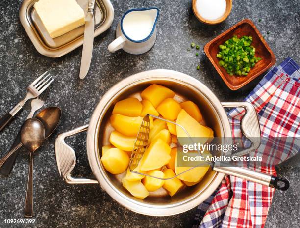 preparing to making a mashed potatoes - potato masher stockfoto's en -beelden