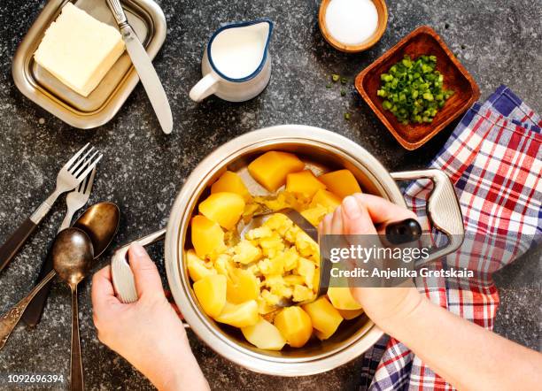 cooking a mashed potatoes - potato masher stockfoto's en -beelden