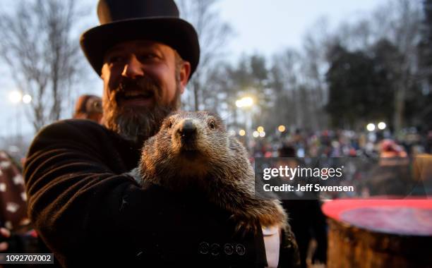 Handler AJ Dereume holds Punxsutawney Phil after he did not see his shadow predicting an early spring during the 133rd annual Groundhog Day...