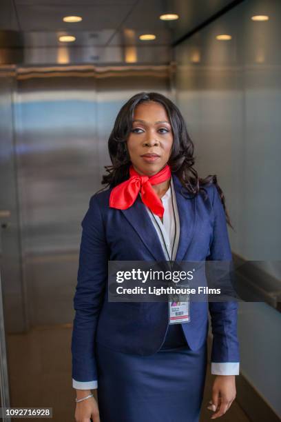 airline flight attendant stands in airport elevator. - berkshire england stock pictures, royalty-free photos & images